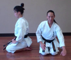 two people kneeling (seiza) - one faces side, one faces front